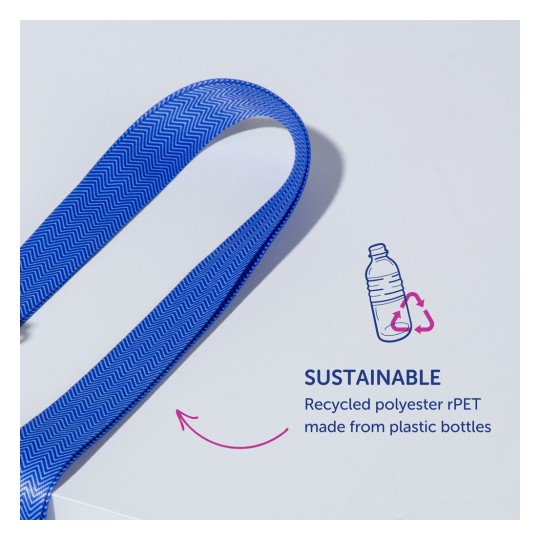 Obrázek zobrazuje modrou stužku se zubatým vzorem, označenou jako udržitelná. Naznačuje, že je vyrobena z recyklovaného polyesteru rPET pocházejícího z plastových lahví.