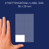 Obrázek zobrazuje ruku vedle archu štítků, přičemž výše je uvedena velikost štítku 38 x 29 mm.