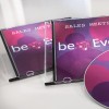 Obrázek zobrazuje dva obaly na CD s názvem 'Sales Meeting' a disk s barevným designem. Design obsahuje kruhy v odstínech růžové a fialové spolu s textem 'beEven.'