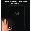 Obrázek zobrazuje ruku pod listem A4 s označením velikosti etikety jako Ø 10 mm. Pozadí je tmavé a text je v němčině, přičemž uvádí velikost etikety.